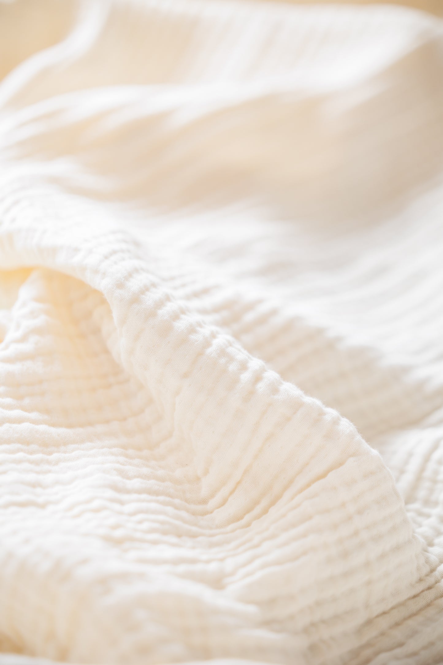 100% cotton gauze blanket with a crinkled texture, available in natural color
