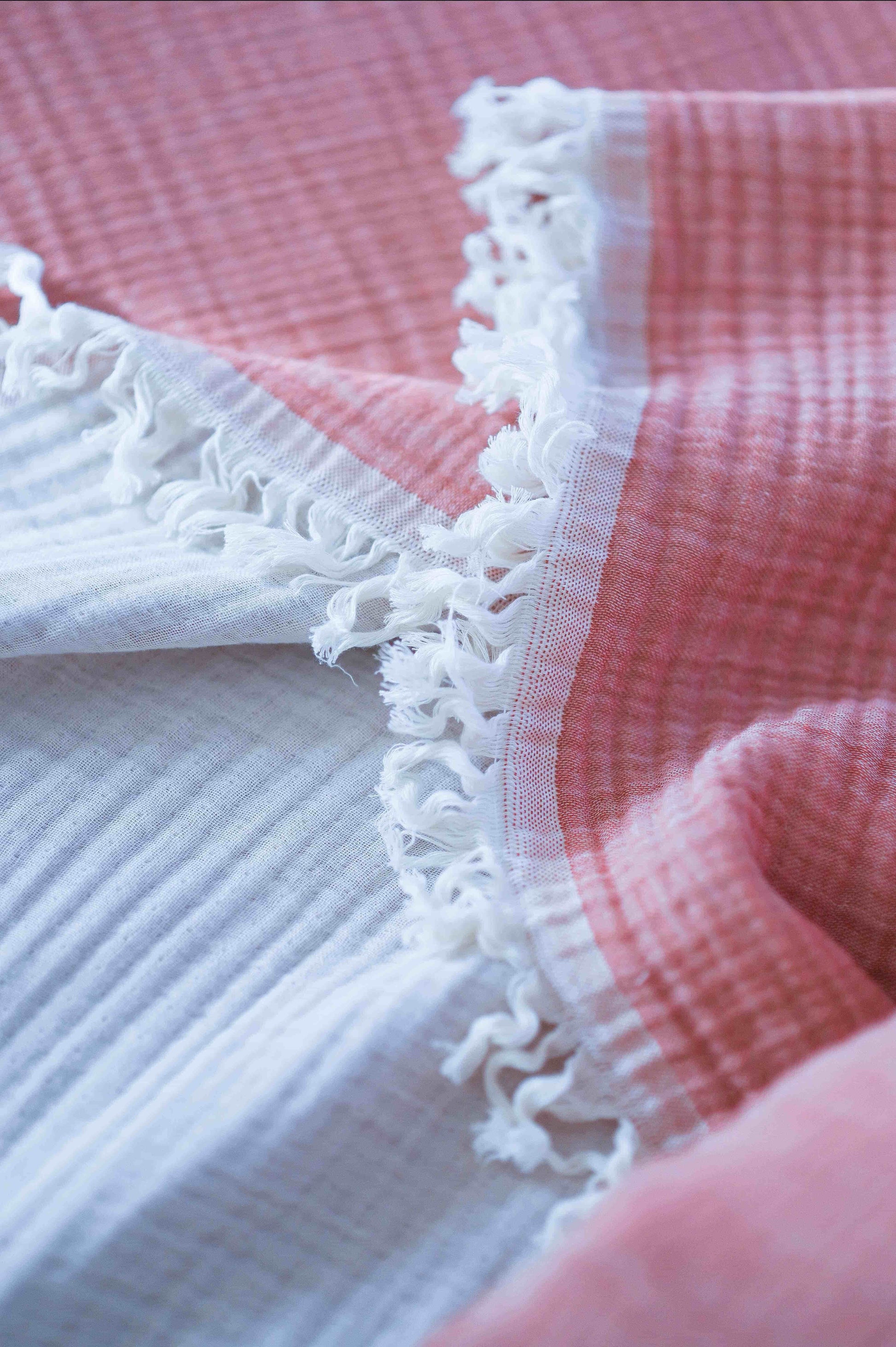 All-Season Comfort – Lightweight muslin blanket in coral pink & ecru for year-round warmth and breathability.